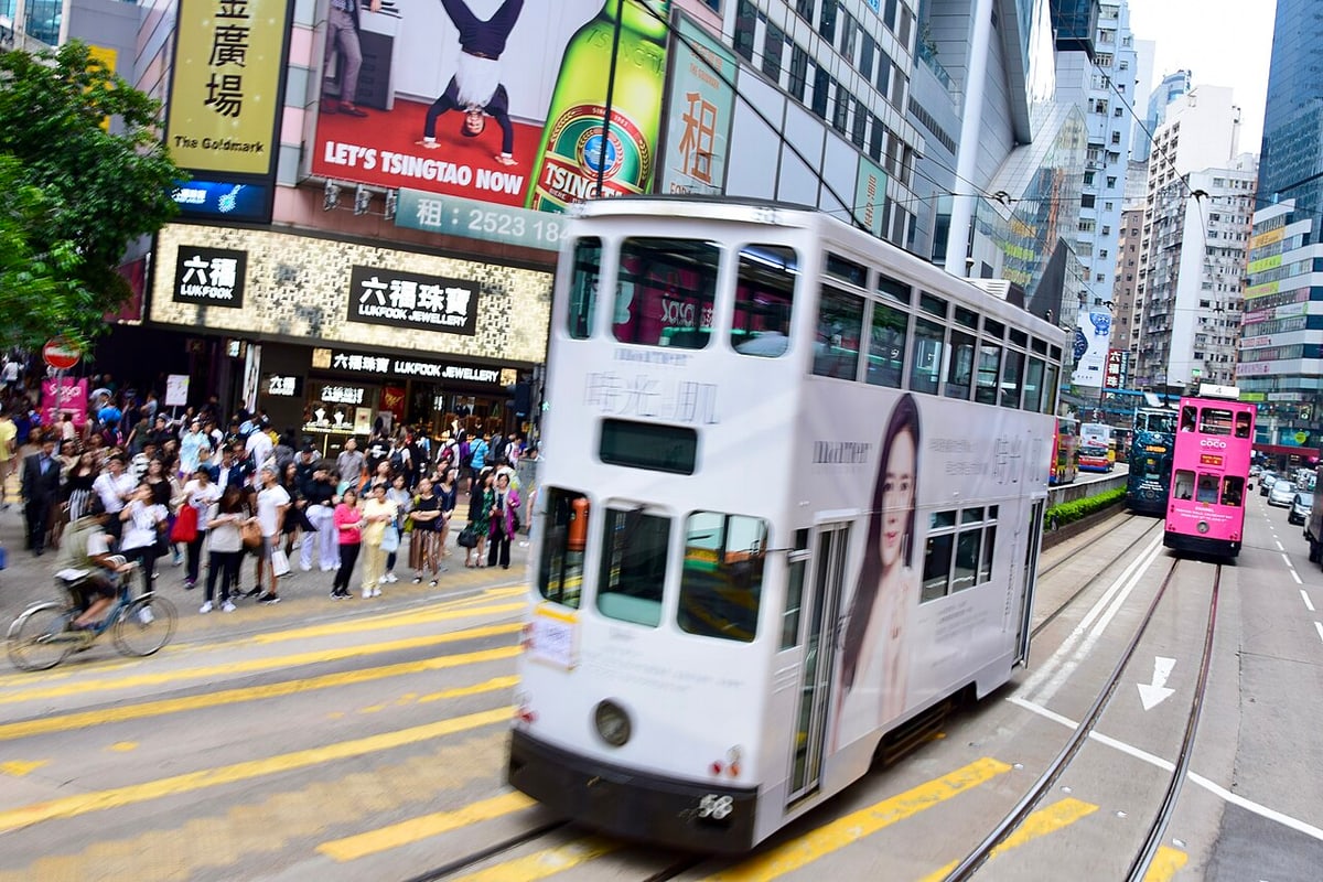 Double-decker Hong Kong tram travelling along a city street